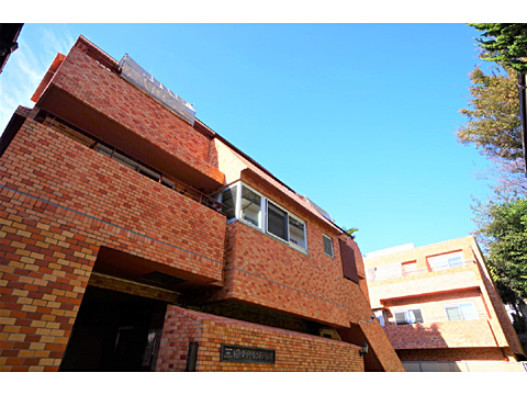 現地外観写真 建物外観。レンガ風の落ち着いた色調のタイル張り